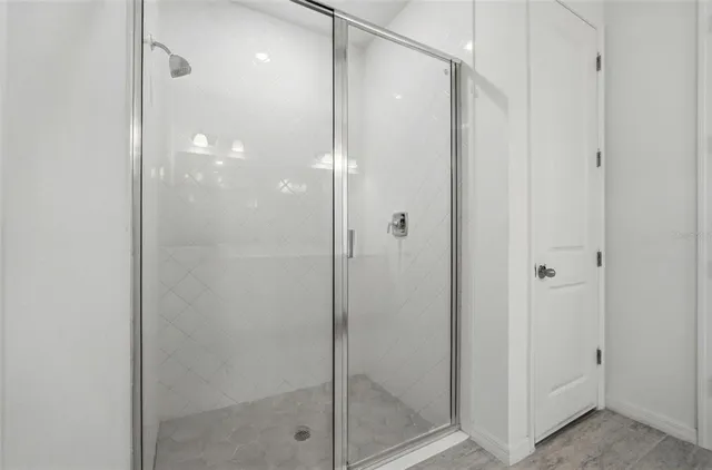 a bathroom with a glass shower door