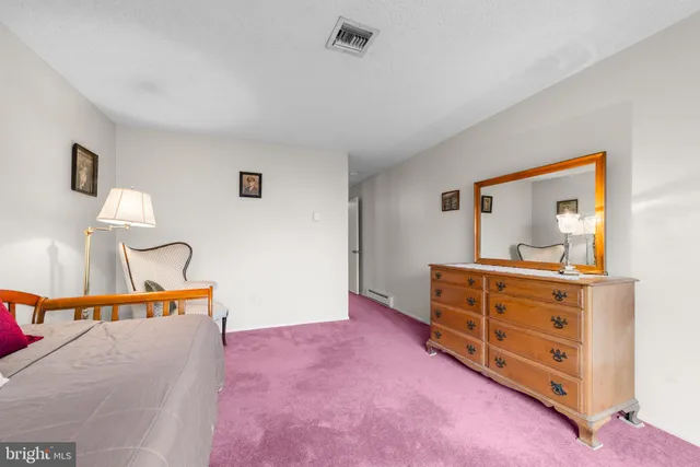 a bed room with a bed and a dresser