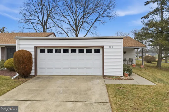 a view of a house with a yard and tree