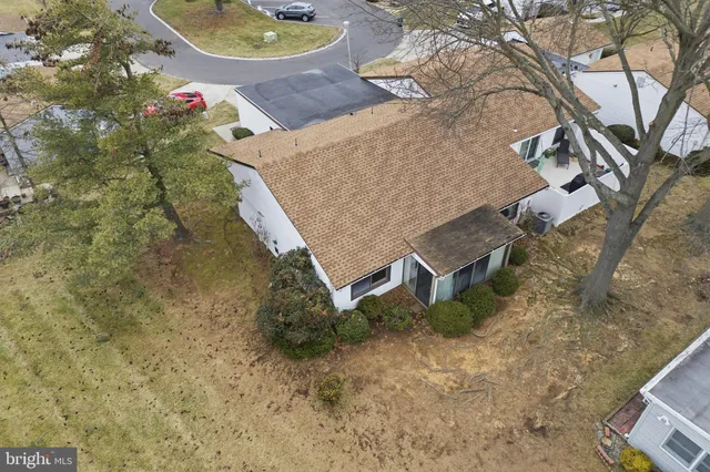 an aerial view of a house with yard and lake view