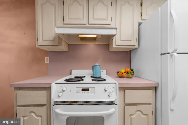 a kitchen with stainless steel appliances granite countertop a stove a microwave and cabinets