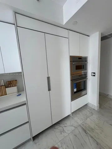 a view of a storage and utility room with washer and dryer