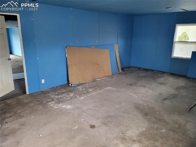 a view of an empty room and a window