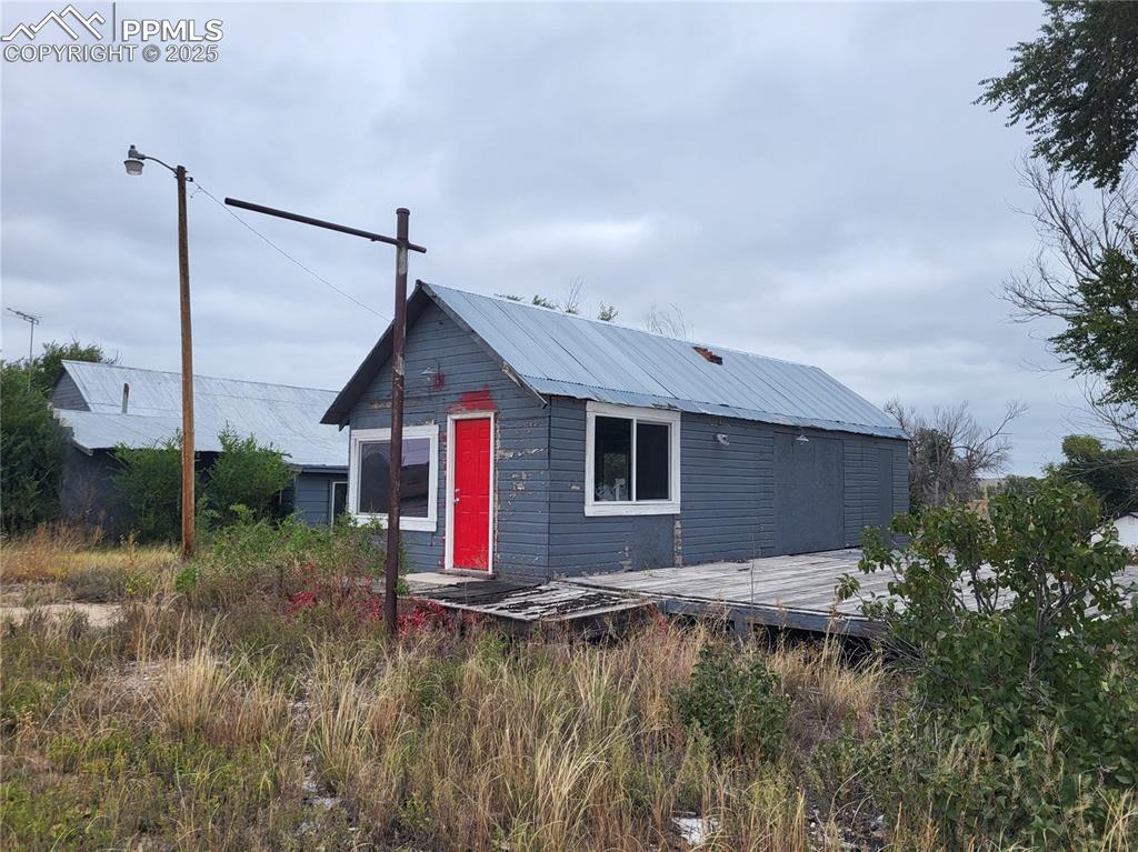 37131 Highway 24 Matheson, CO 80830 - Photo 8 of 12 a backyard of a house with plants and large tree