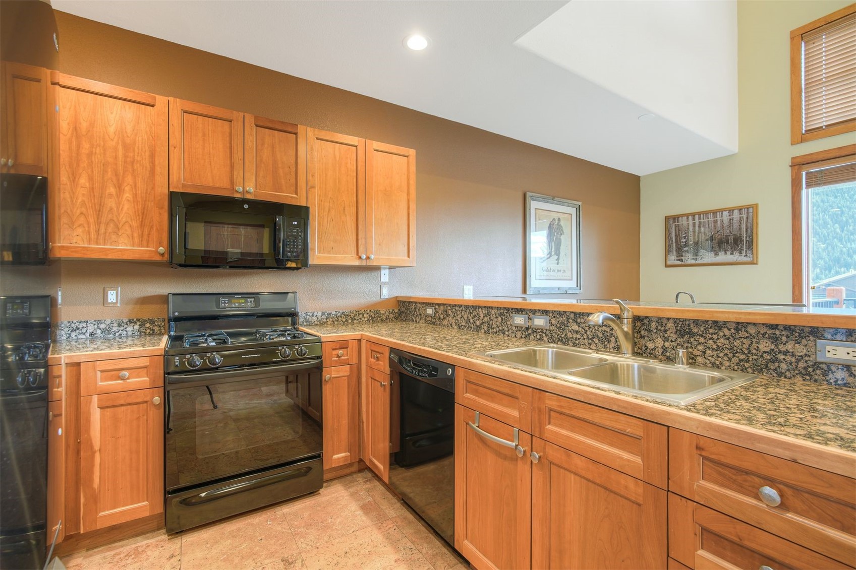 71 Antlers Gulch Road, Unit 303 Keystone, CO 80435 - Photo 9 of 35 a kitchen with a sink stove and microwave