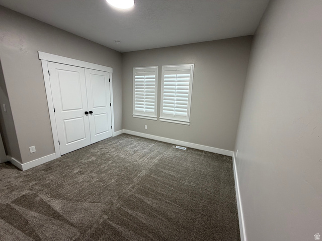 2350 North 1075 West Helper, UT 84526 - Photo 24 of 49 Unfurnished bedroom with carpet and a closet