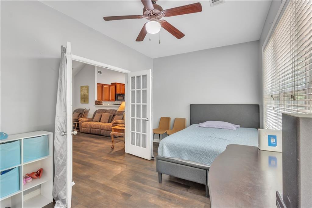 4044 Amberleigh Trace Gainesville, GA 30507 - Photo 14 of 21 a bedroom with a bed and a chandelier