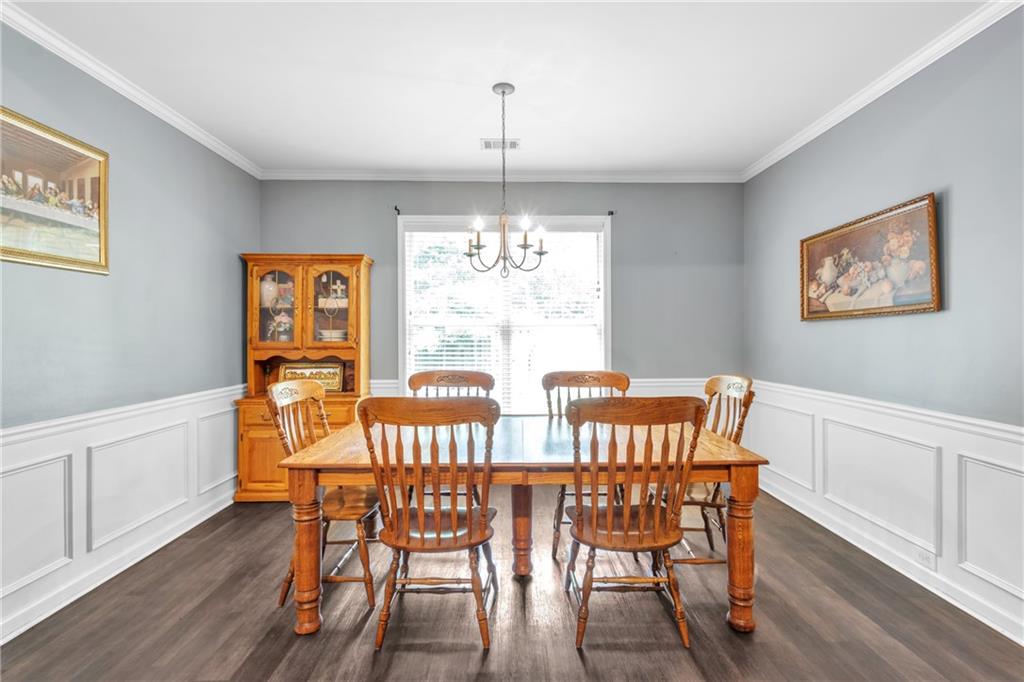 4044 Amberleigh Trace Gainesville, GA 30507 - Photo 7 of 21 a view of a dining room with furniture window and wooden floor