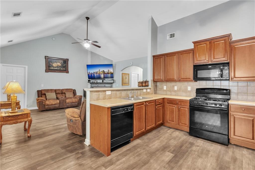 4044 Amberleigh Trace Gainesville, GA 30507 - Photo 10 of 21 a kitchen with stainless steel appliances granite countertop a stove and cabinets