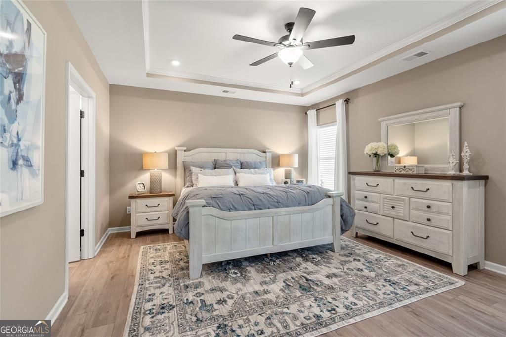 200 Roy Drive Calhoun, GA 30701 - Photo 12 of 29 a bedroom with a large bed and a chandelier