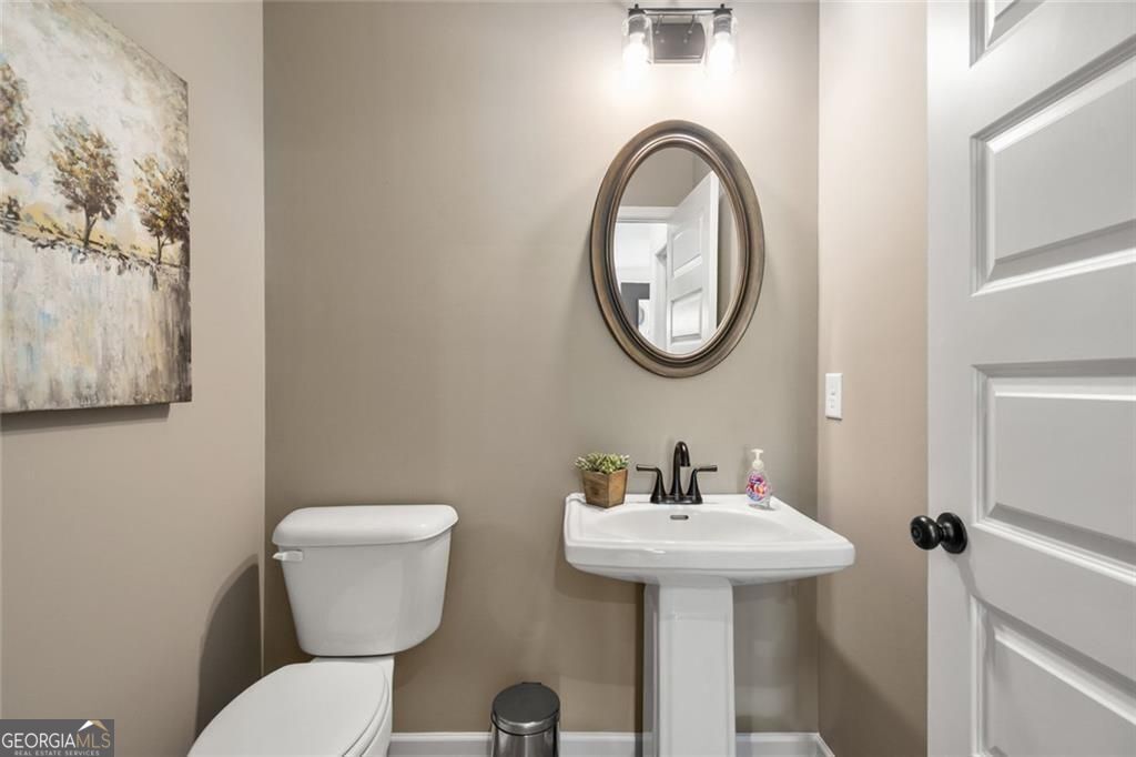 200 Roy Drive Calhoun, GA 30701 - Photo 19 of 29 a bathroom with a toilet sink and mirror
