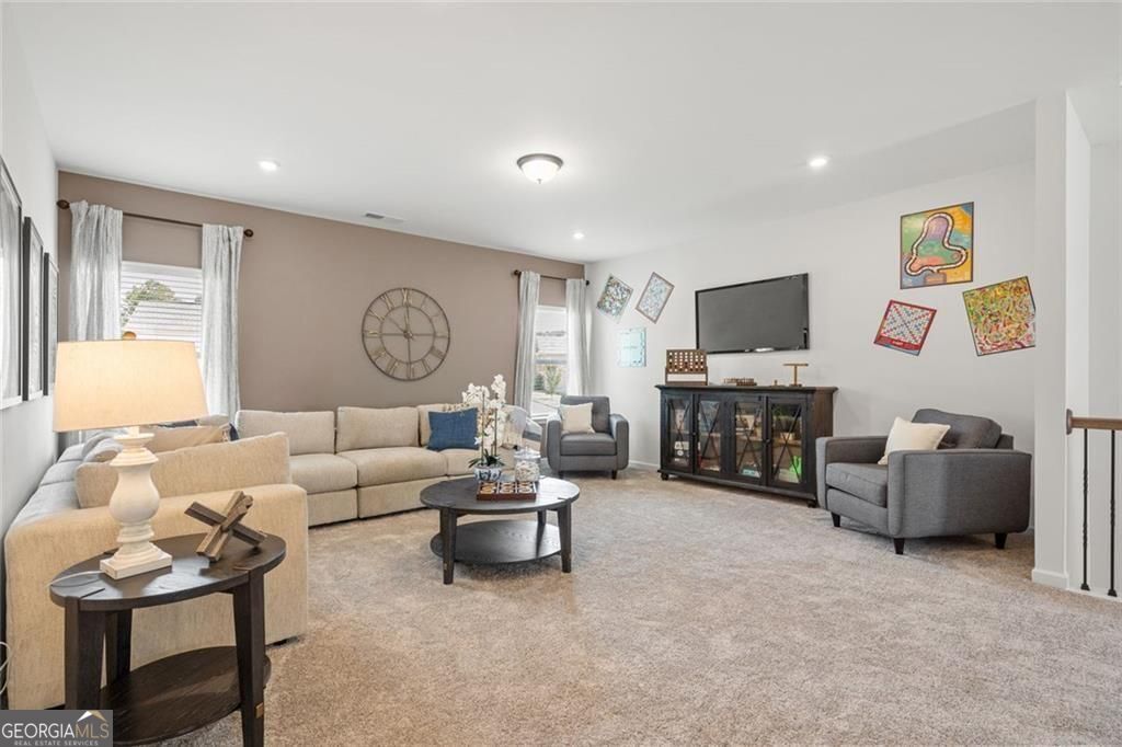 200 Roy Drive Calhoun, GA 30701 - Photo 22 of 29 a living room with furniture and a flat screen tv