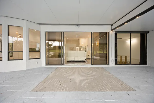 a green field with flowers in front of it