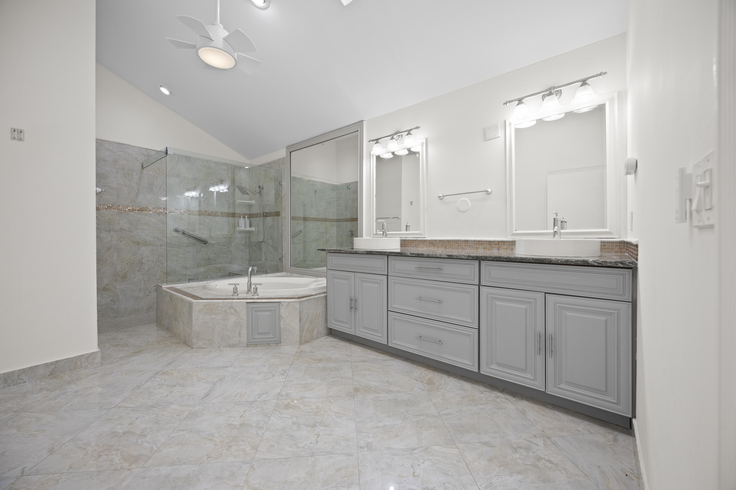 10106 Spyglass Way Boca Raton, FL 33498 - Photo 15 of 56 a bathroom with a double vanity sink a toilet and mirror