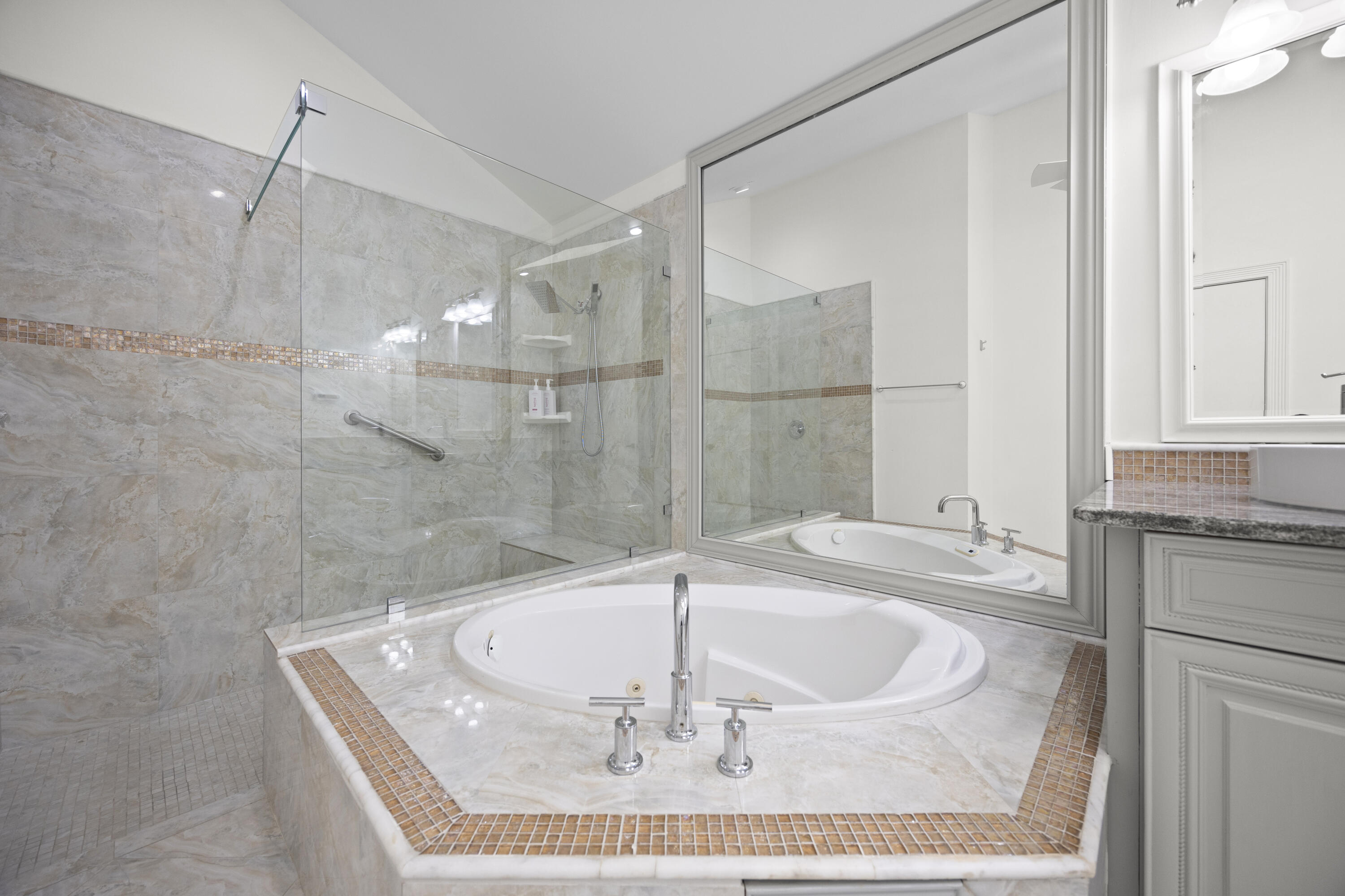 10106 Spyglass Way Boca Raton, FL 33498 - Photo 16 of 56 a bathroom with a granite countertop sink a mirror and bathtub