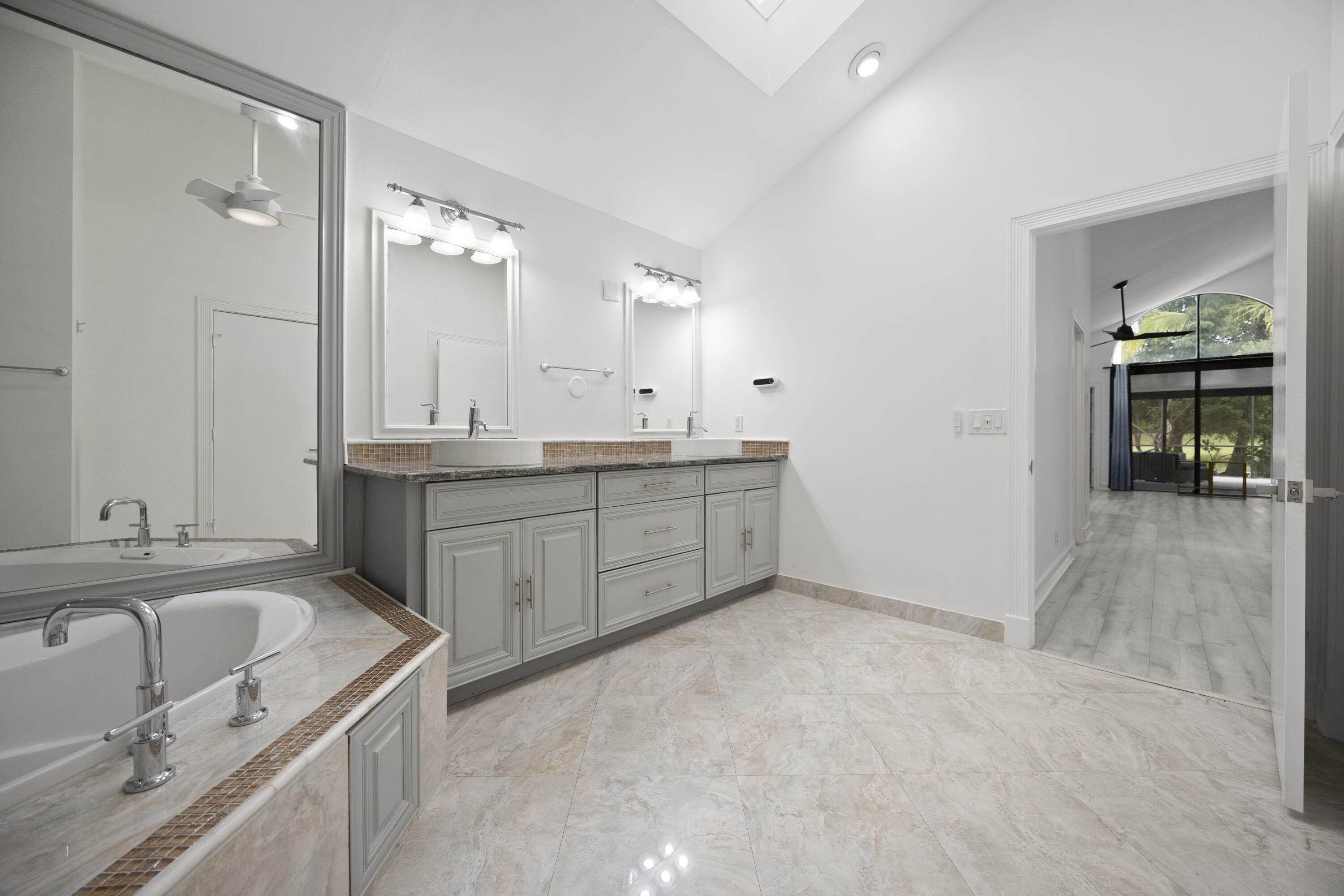 10106 Spyglass Way Boca Raton, FL 33498 - Photo 17 of 56 a bathroom with a granite countertop sink and a mirror
