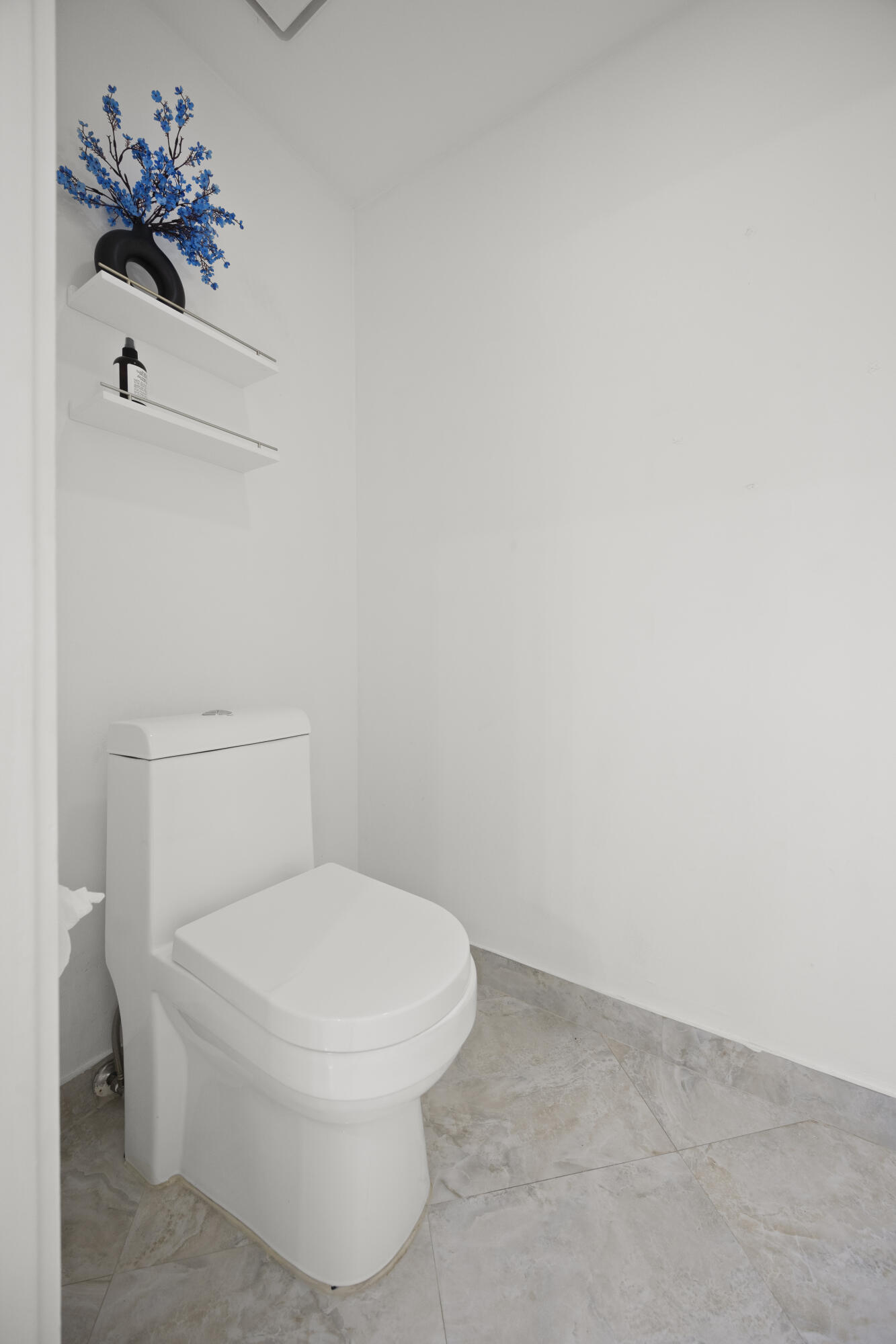 10106 Spyglass Way Boca Raton, FL 33498 - Photo 18 of 56 a white toilet sitting next to a white sink