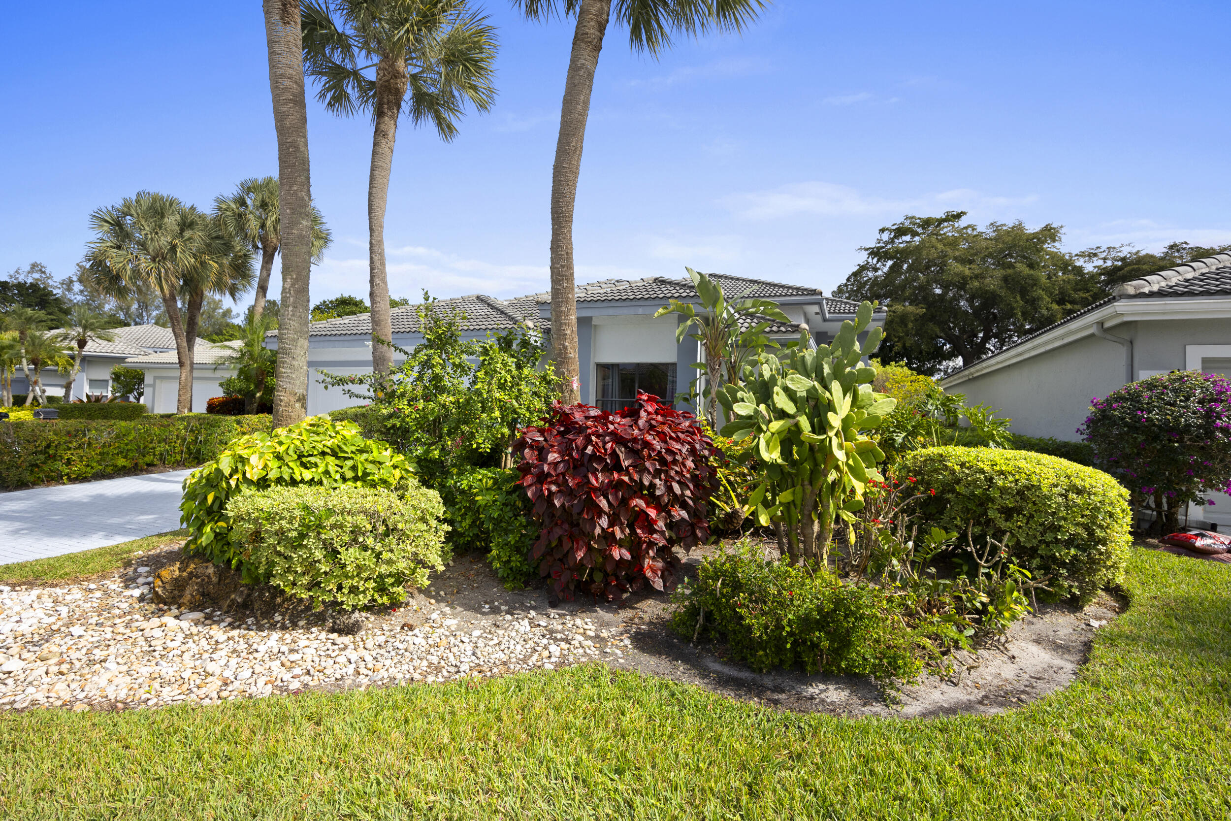 10106 Spyglass Way Boca Raton, FL 33498 - Photo 2 of 56 a green field with flowers in front of it