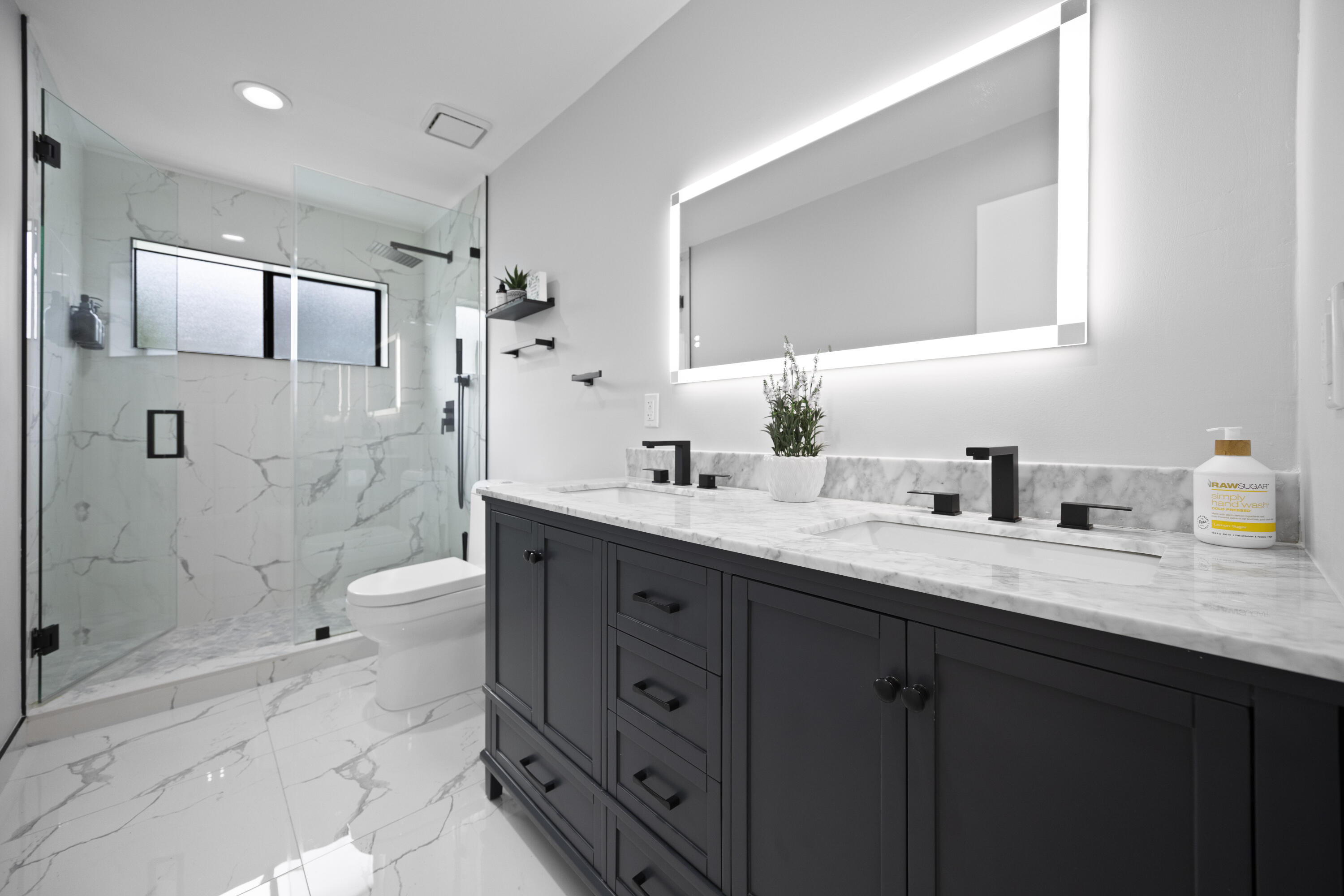 10106 Spyglass Way Boca Raton, FL 33498 - Photo 22 of 56 a bathroom with a granite countertop sink mirror and shower