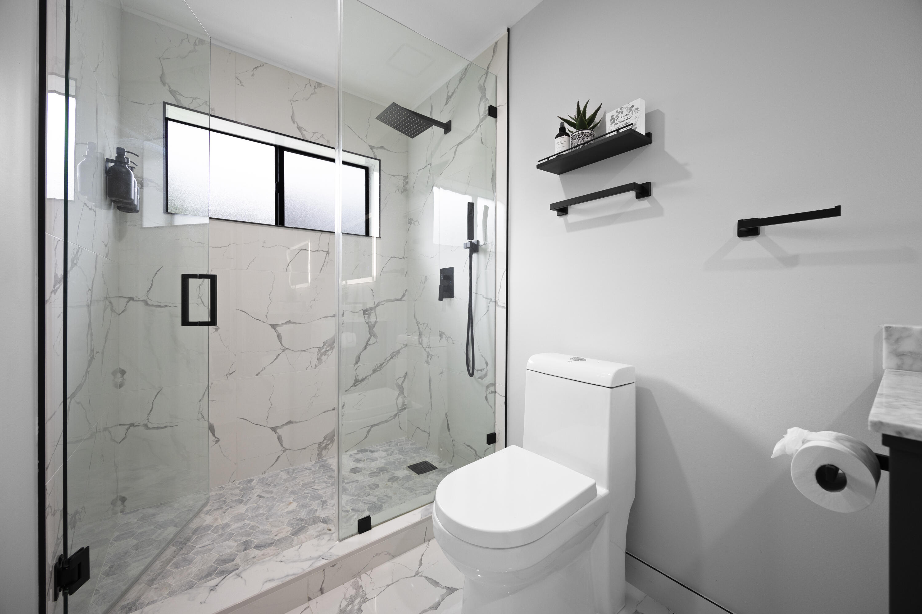 10106 Spyglass Way Boca Raton, FL 33498 - Photo 23 of 56 a bathroom with a granite countertop toilet a sink and shower