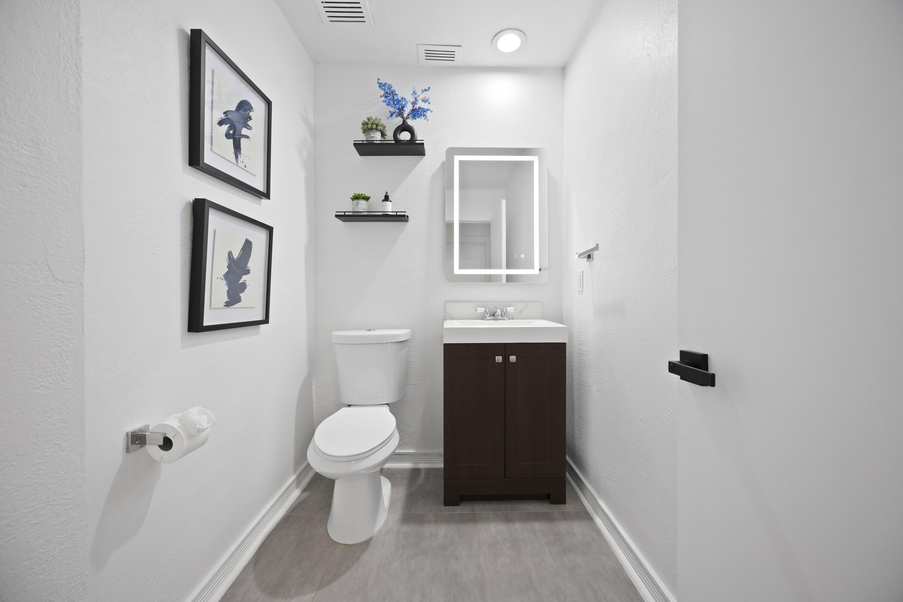 10106 Spyglass Way Boca Raton, FL 33498 - Photo 24 of 56 a bathroom with a toilet sink and mirror