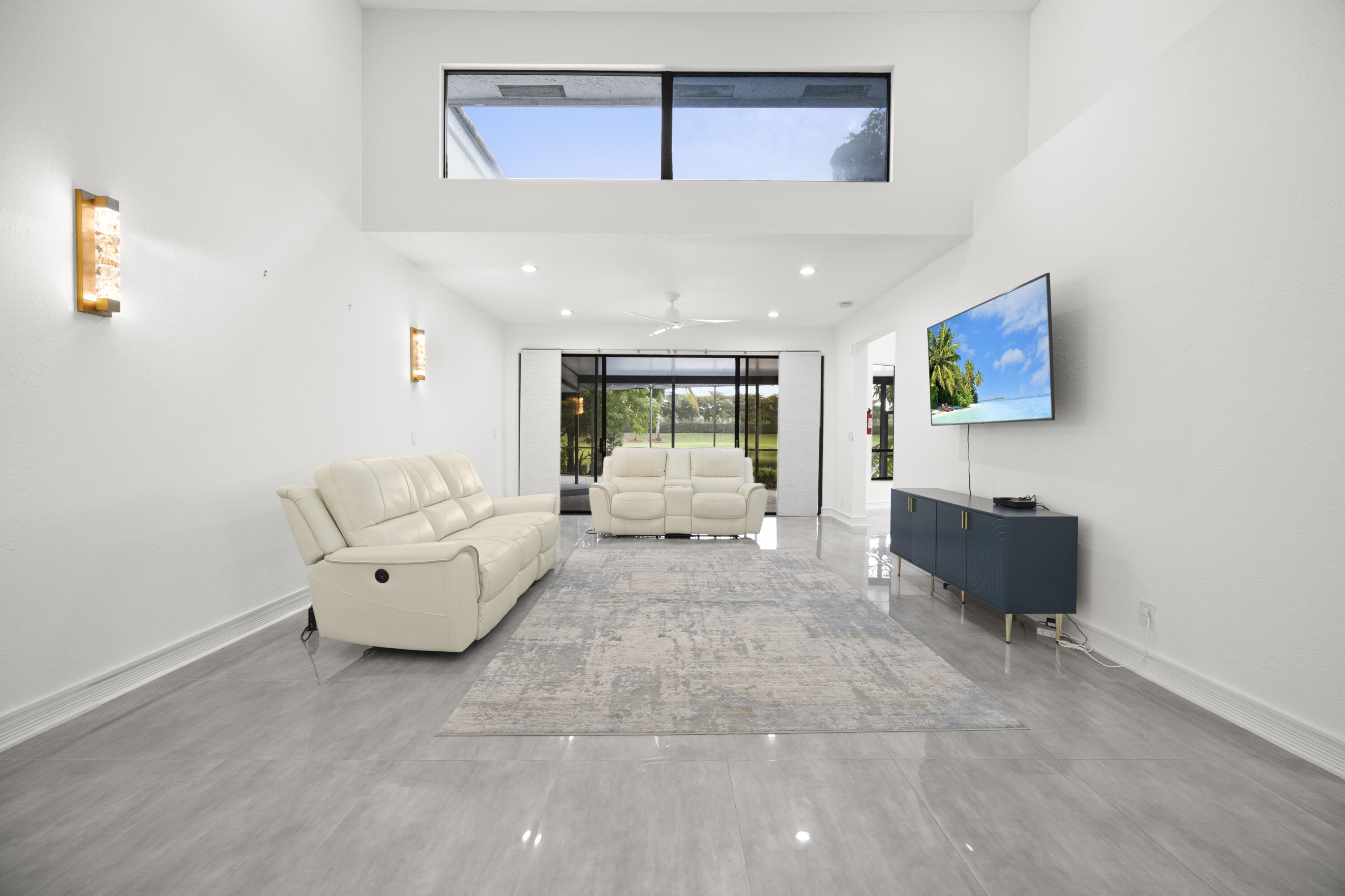 10106 Spyglass Way Boca Raton, FL 33498 - Photo 31 of 56 a living room with furniture and a flat screen tv