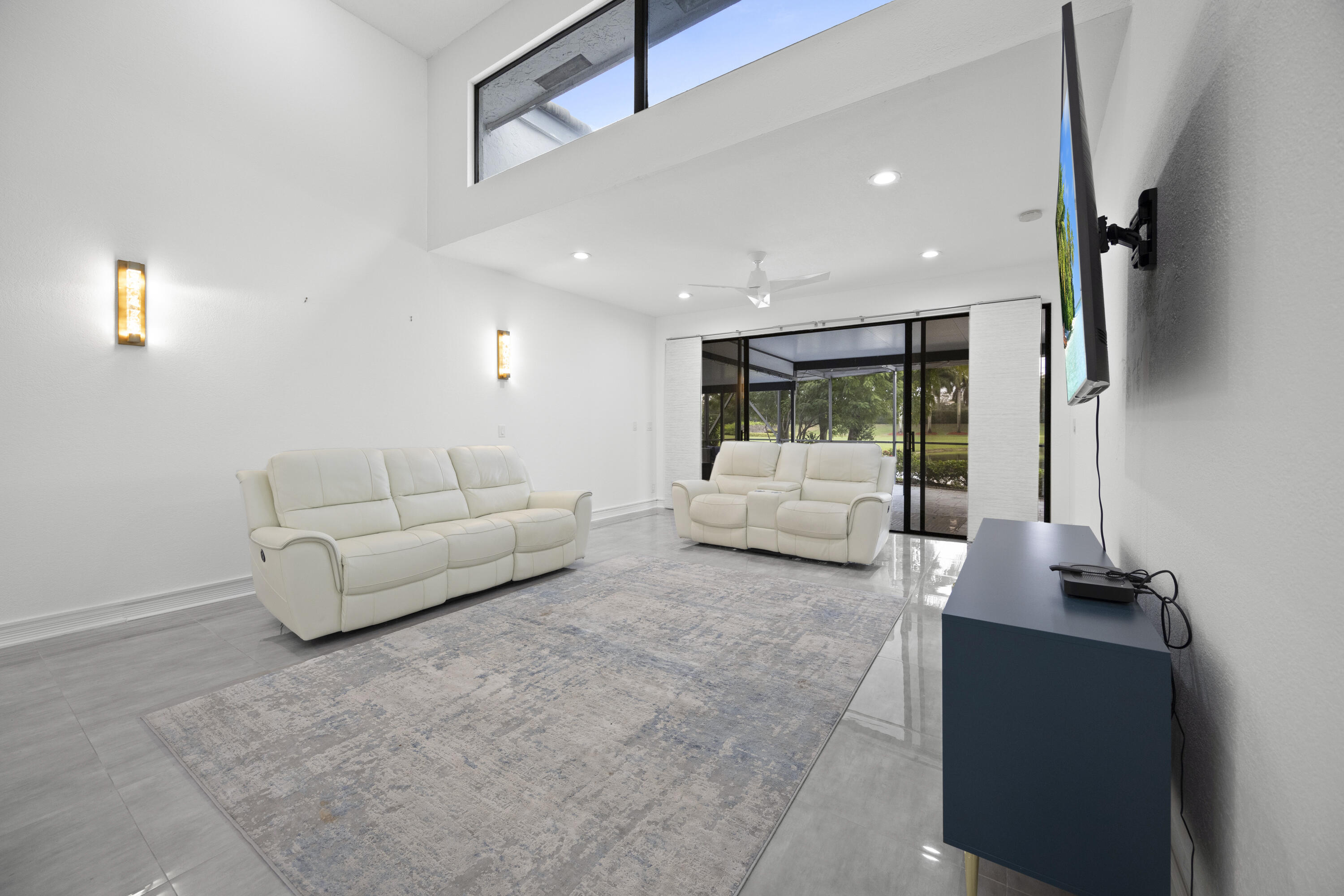 10106 Spyglass Way Boca Raton, FL 33498 - Photo 32 of 56 a living room with furniture and a flat screen tv