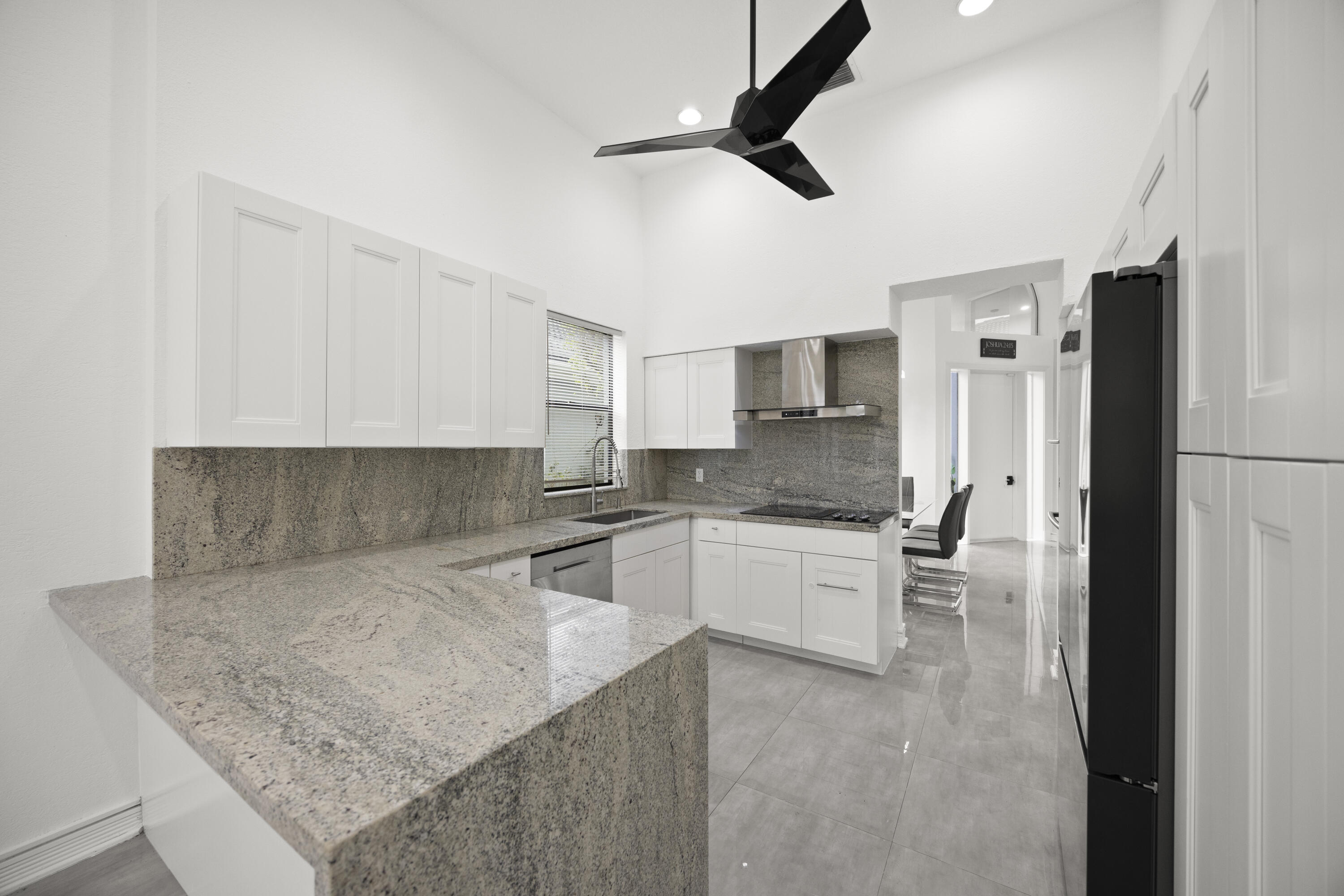 10106 Spyglass Way Boca Raton, FL 33498 - Photo 37 of 56 a kitchen with granite countertop a sink appliances and cabinets