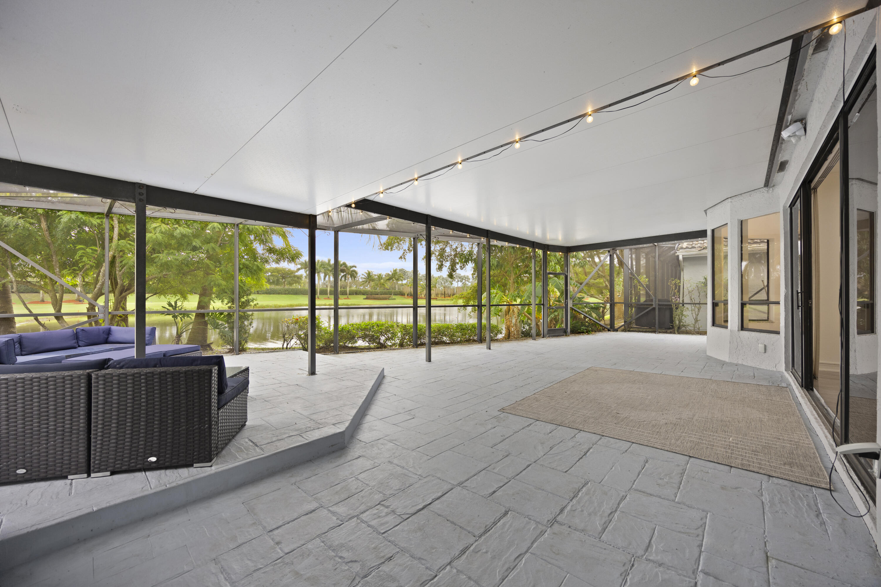 10106 Spyglass Way Boca Raton, FL 33498 - Photo 46 of 56 a view of a porch with furniture and floor to ceiling window