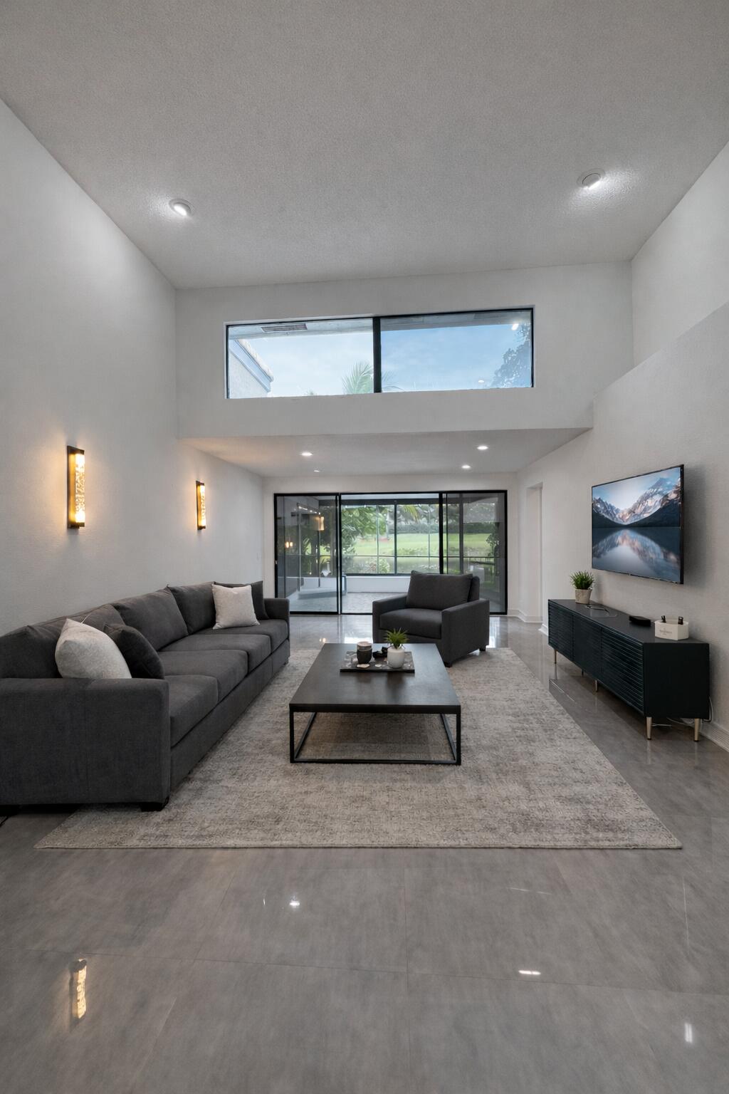 10106 Spyglass Way Boca Raton, FL 33498 - Photo 5 of 56 a living room with furniture and a large window