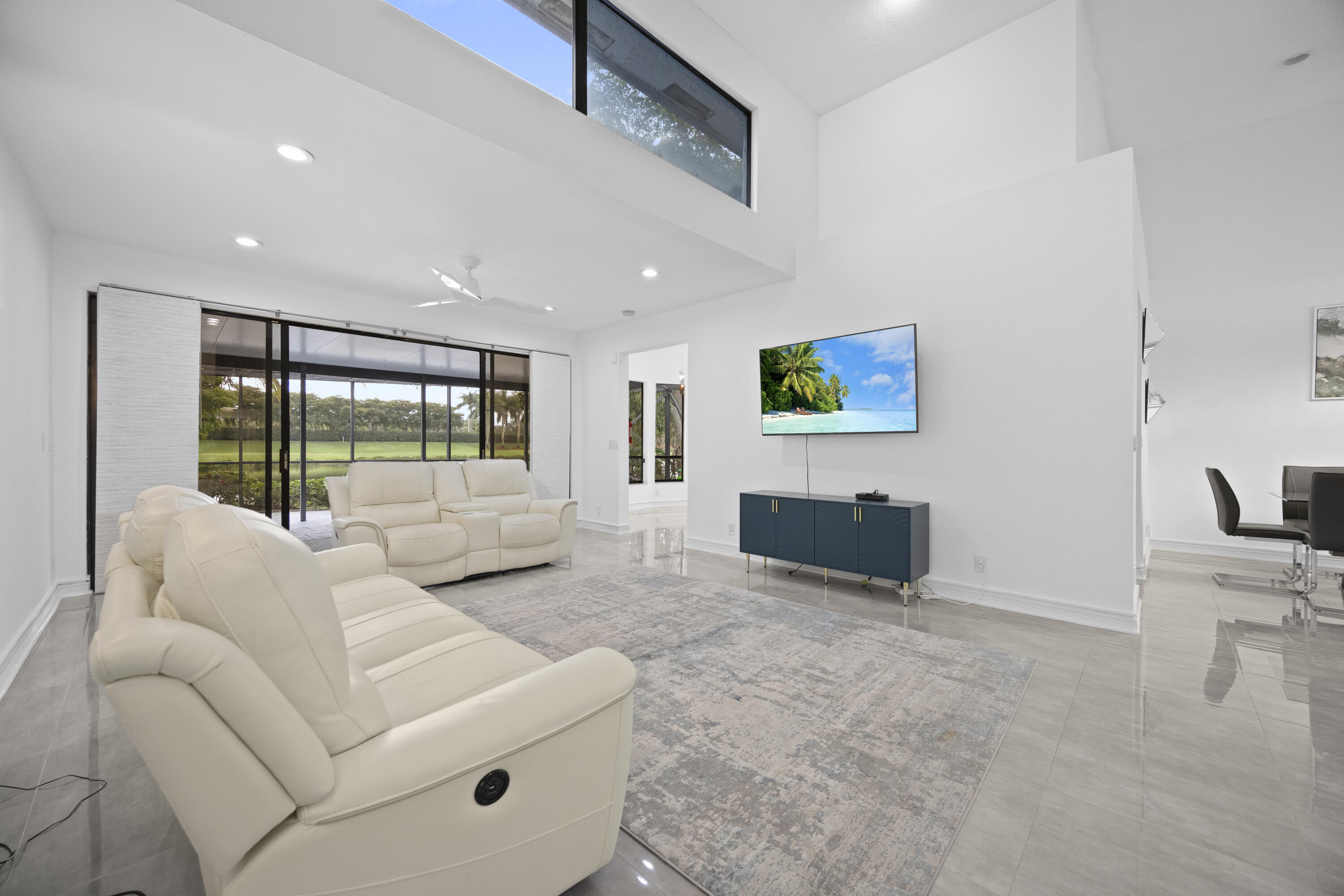 10106 Spyglass Way Boca Raton, FL 33498 - Photo 9 of 56 a living room with furniture a flat screen tv and a large window