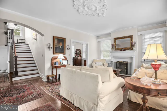 a kitchen with a refrigerator a stove a sink dishwasher and white cabinets with wooden floor