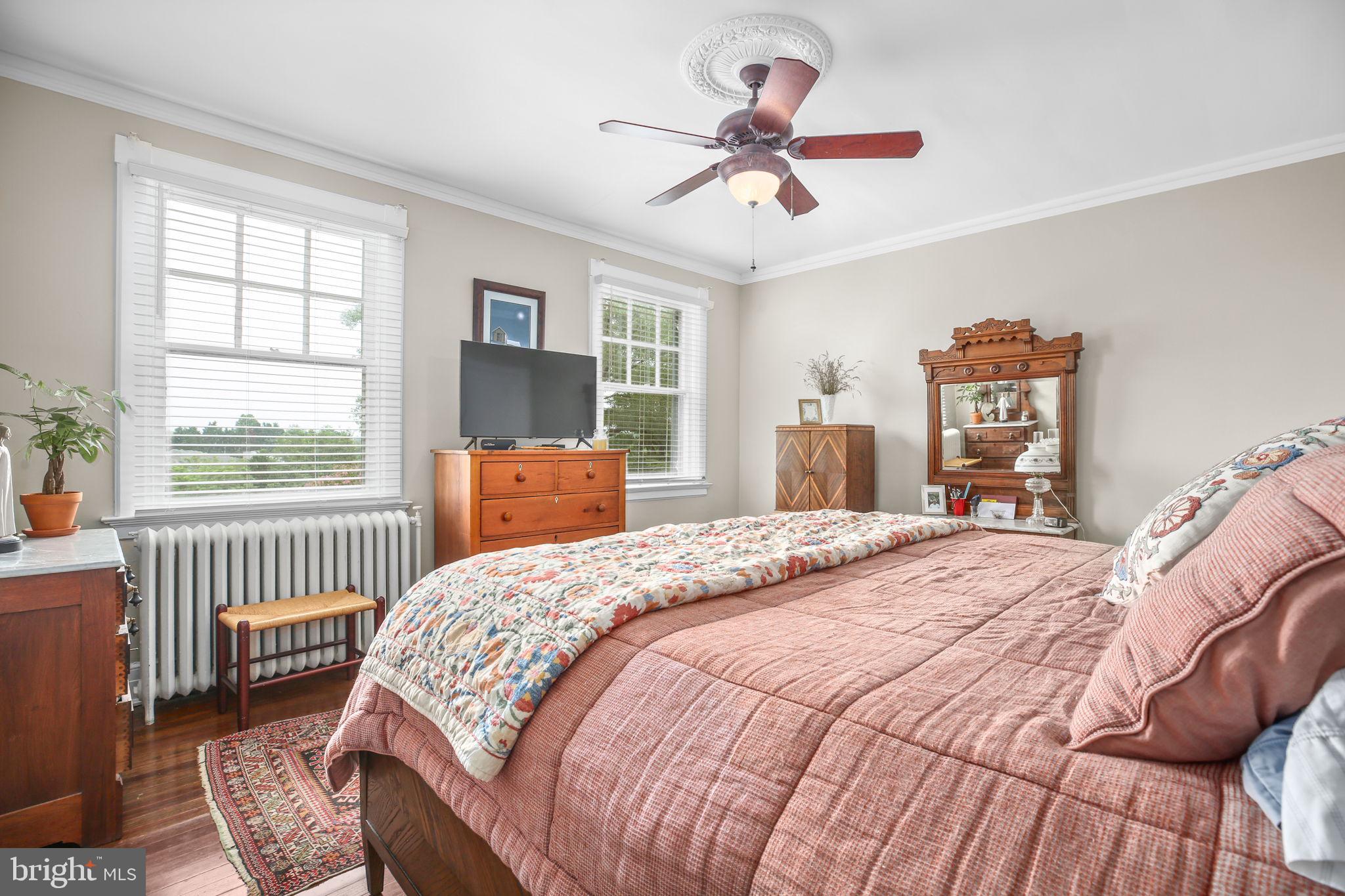 590 North Madison Road Orange, VA 22960 - Photo 30 of 88 a bedroom with a bed and a chandelier