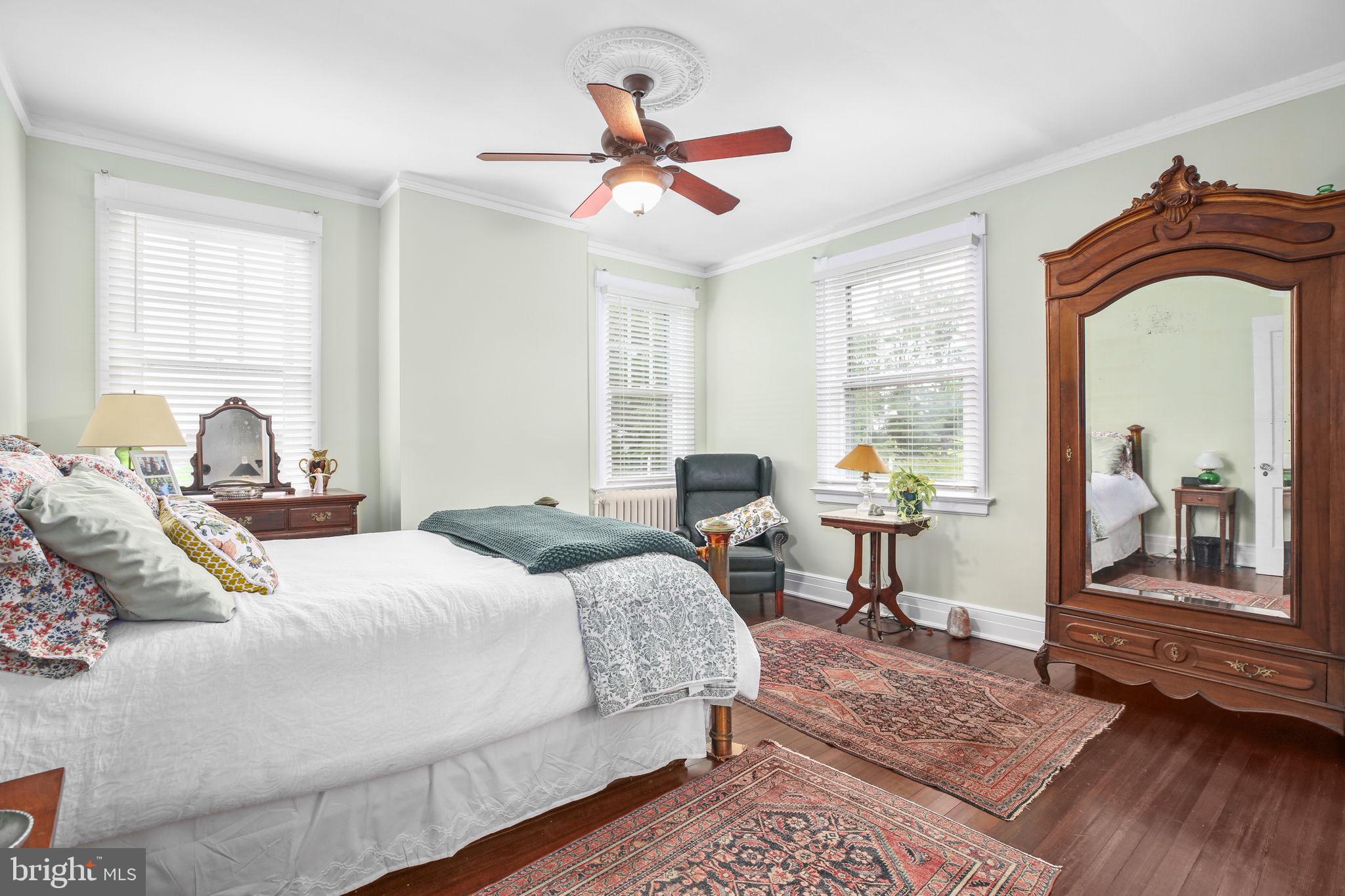 590 North Madison Road Orange, VA 22960 - Photo 31 of 88 a bedroom with a large bed and a chandelier