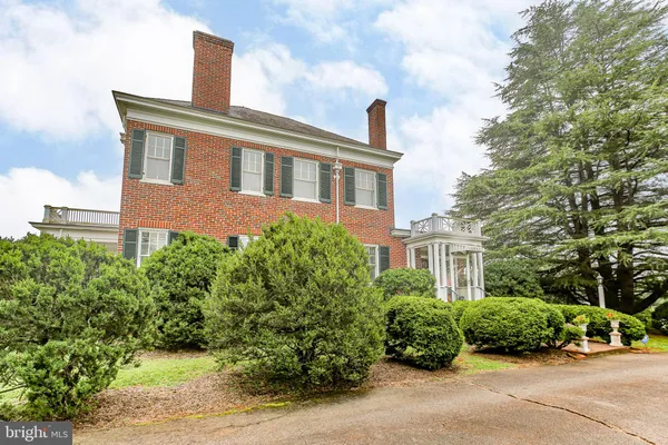 a living room with furniture and a dining table
