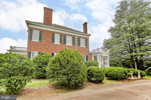a living room with furniture and a dining table