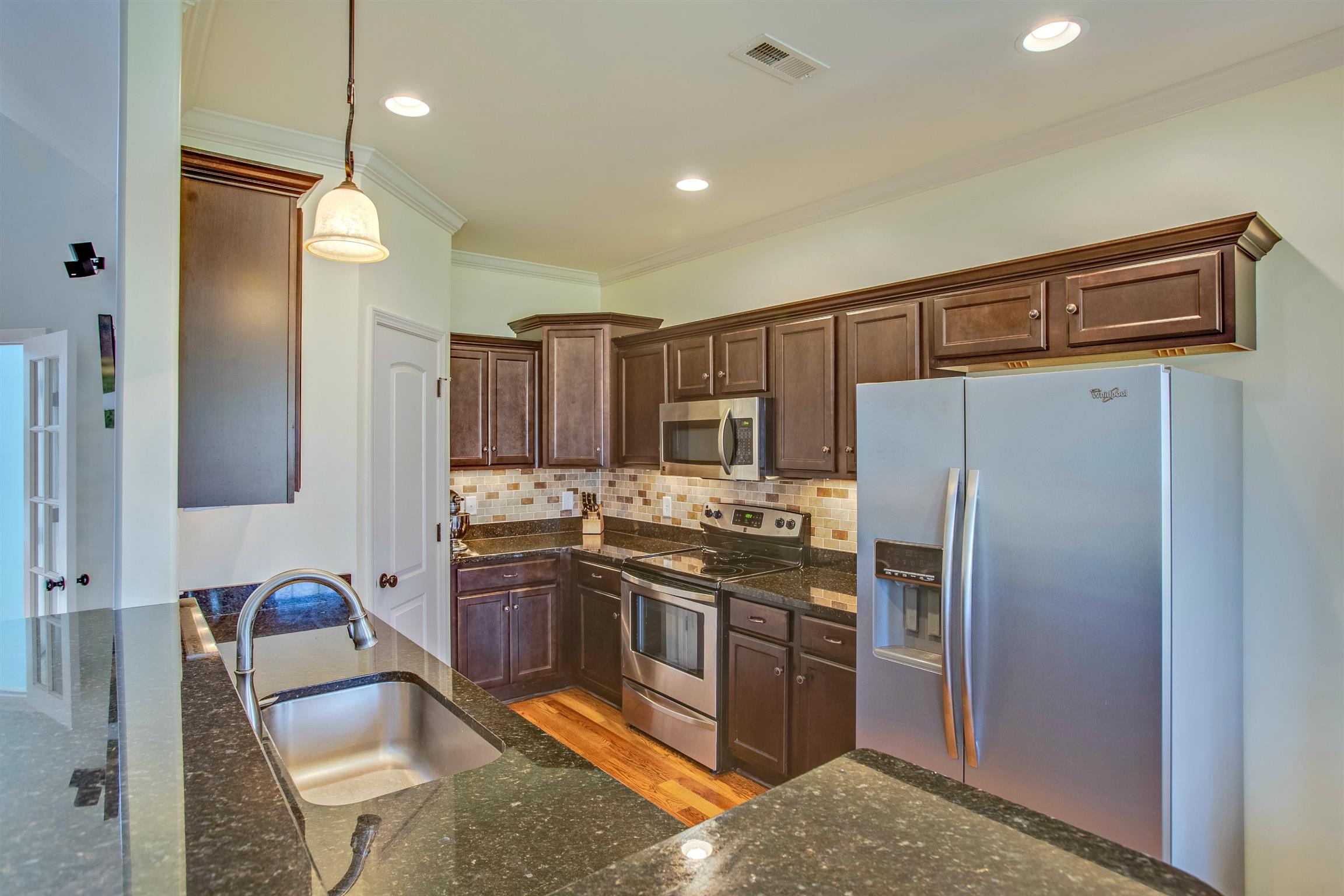 1080 Golf View Way Spring Hill, TN 37174 - Photo 11 of 28 a kitchen with stainless steel appliances granite countertop a refrigerator stove and sink