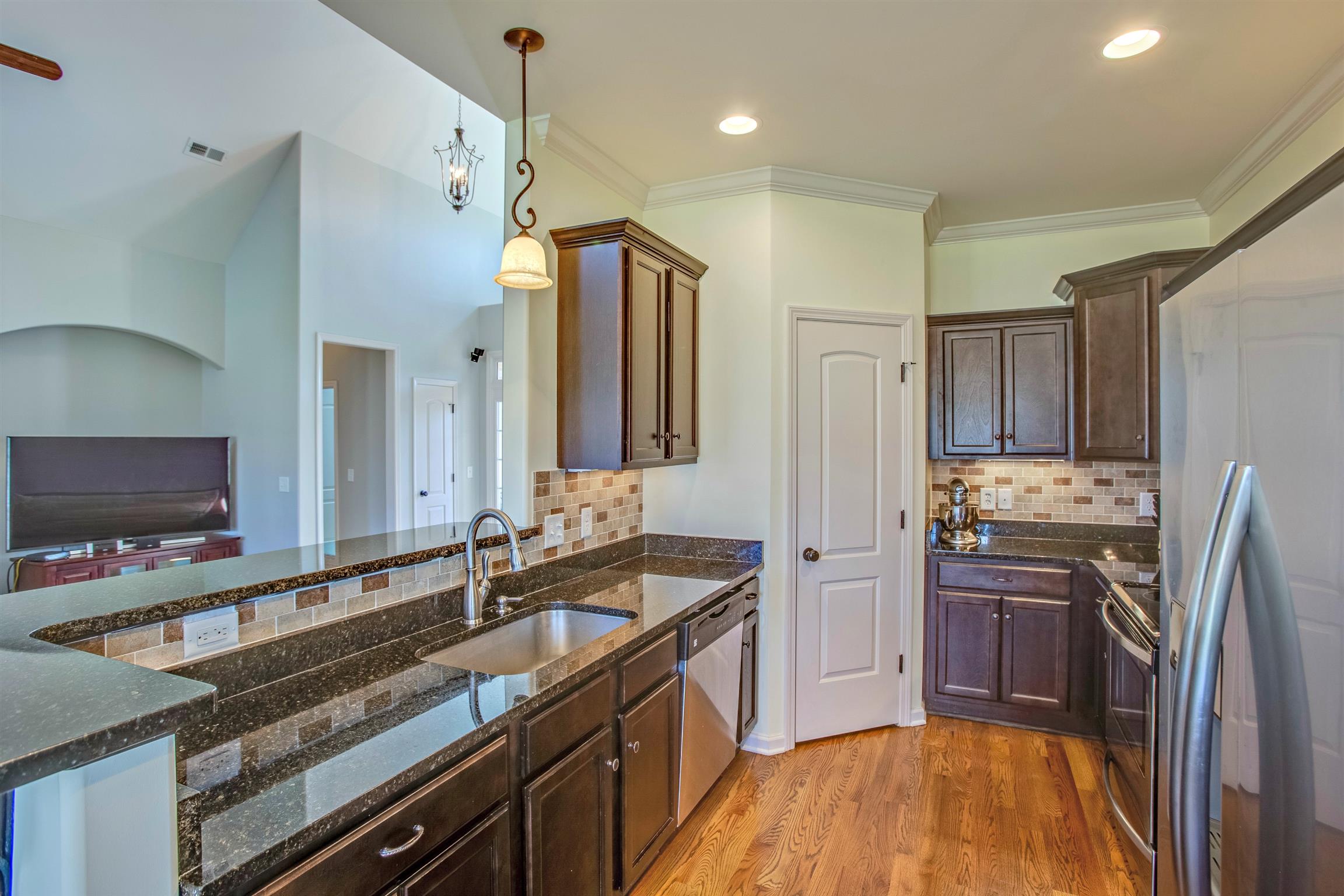 1080 Golf View Way Spring Hill, TN 37174 - Photo 12 of 28 a kitchen with stainless steel appliances granite countertop a sink stove and refrigerator