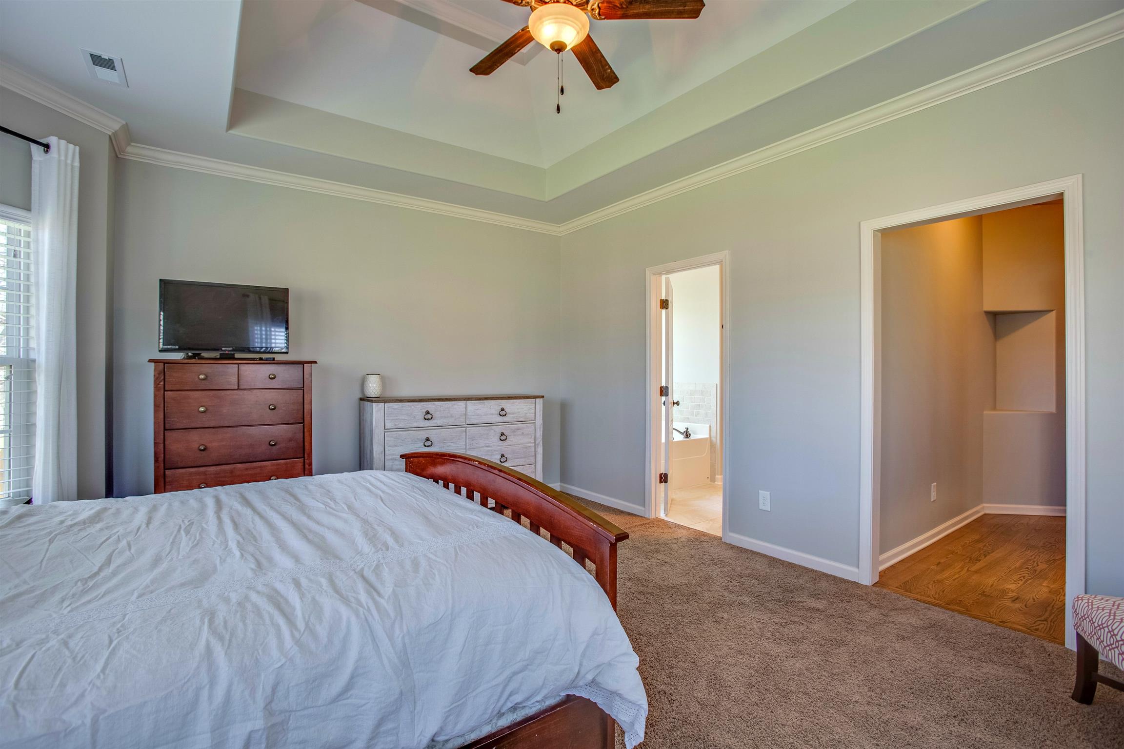 1080 Golf View Way Spring Hill, TN 37174 - Photo 15 of 28 a bedroom with a bed and a chandelier