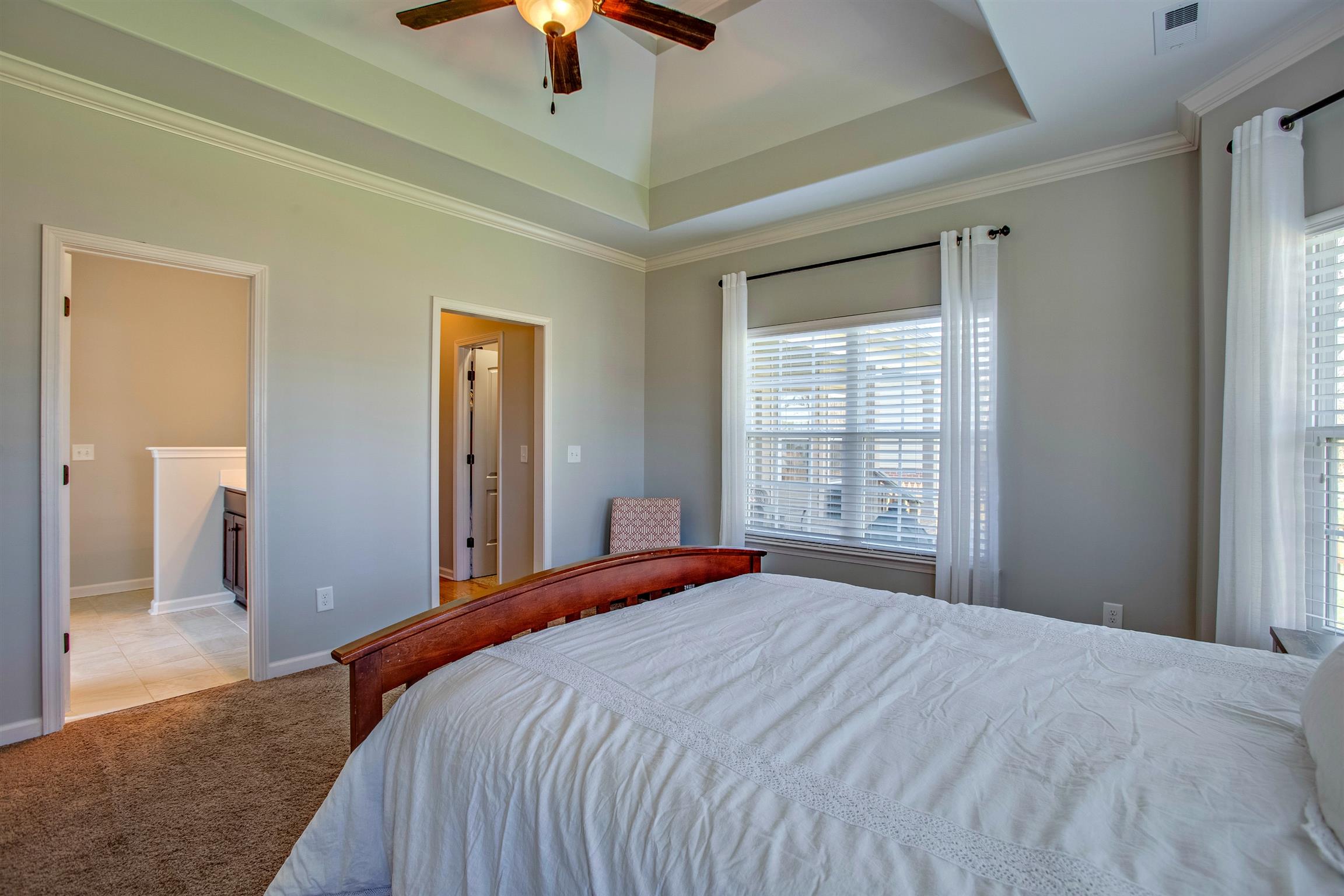 1080 Golf View Way Spring Hill, TN 37174 - Photo 16 of 28 a bedroom with a large bed and a chandelier