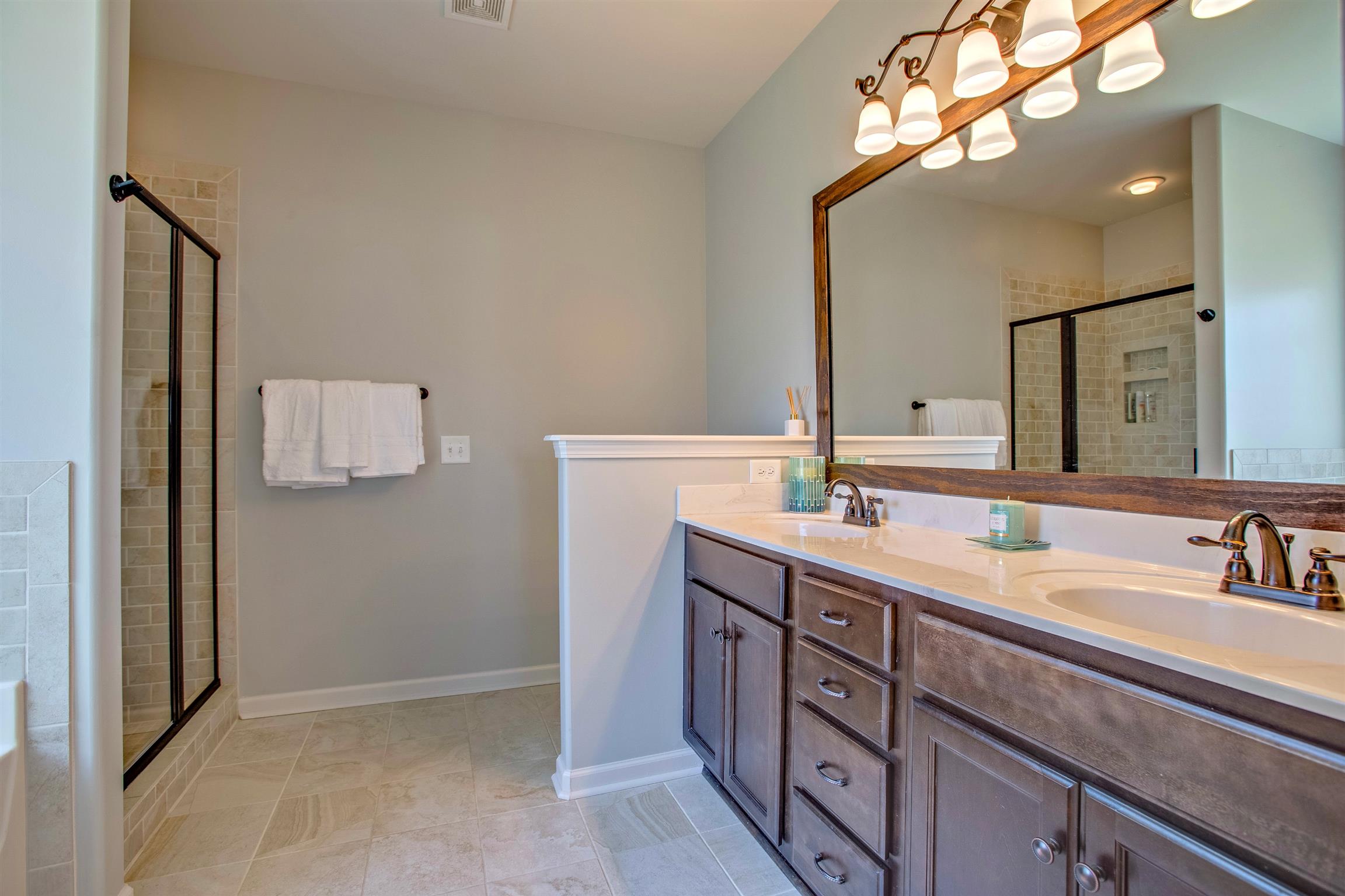 1080 Golf View Way Spring Hill, TN 37174 - Photo 17 of 28 a spacious bathroom with a double vanity sink and a mirror