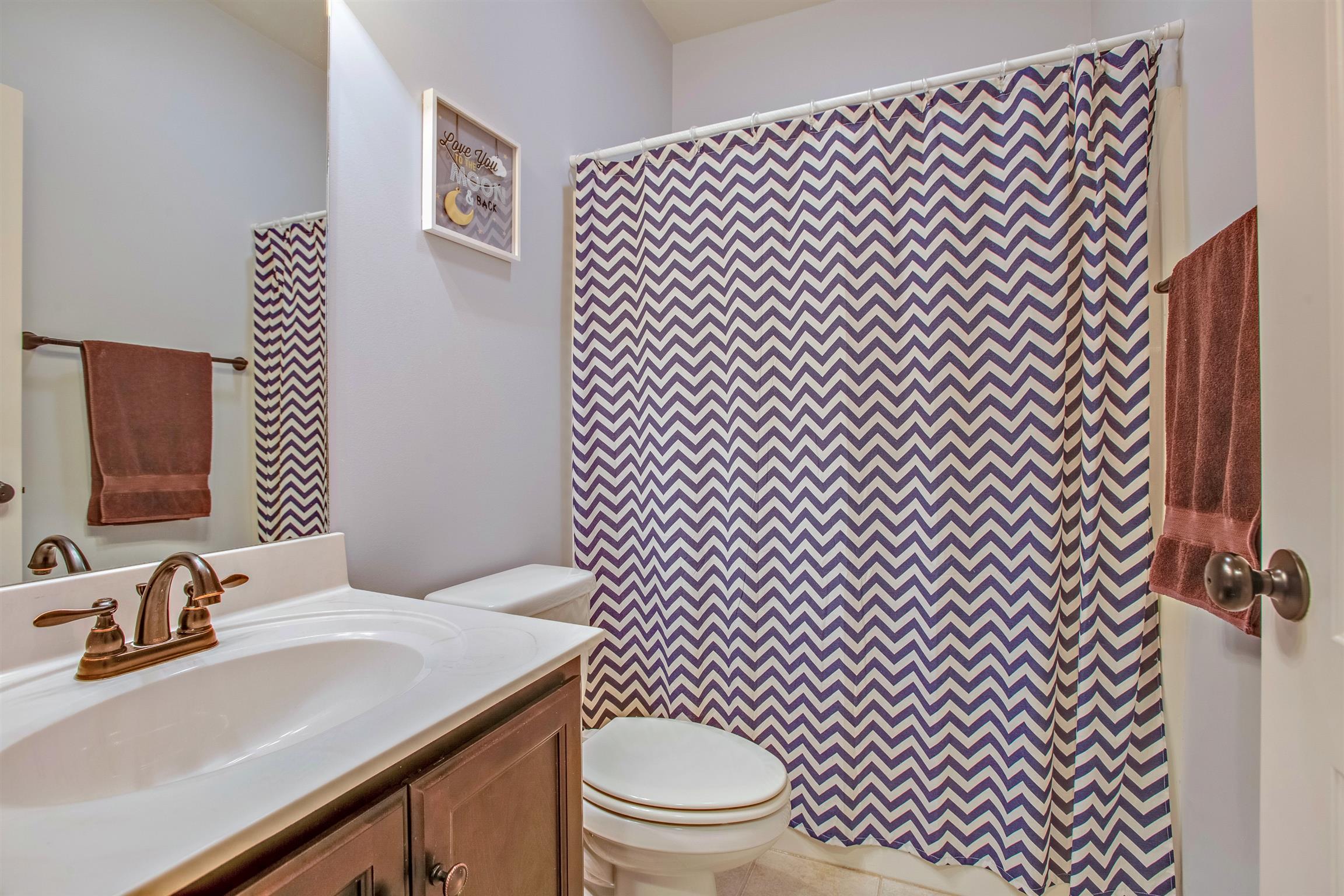 1080 Golf View Way Spring Hill, TN 37174 - Photo 21 of 28 a bathroom with a sink a toilet and mirror