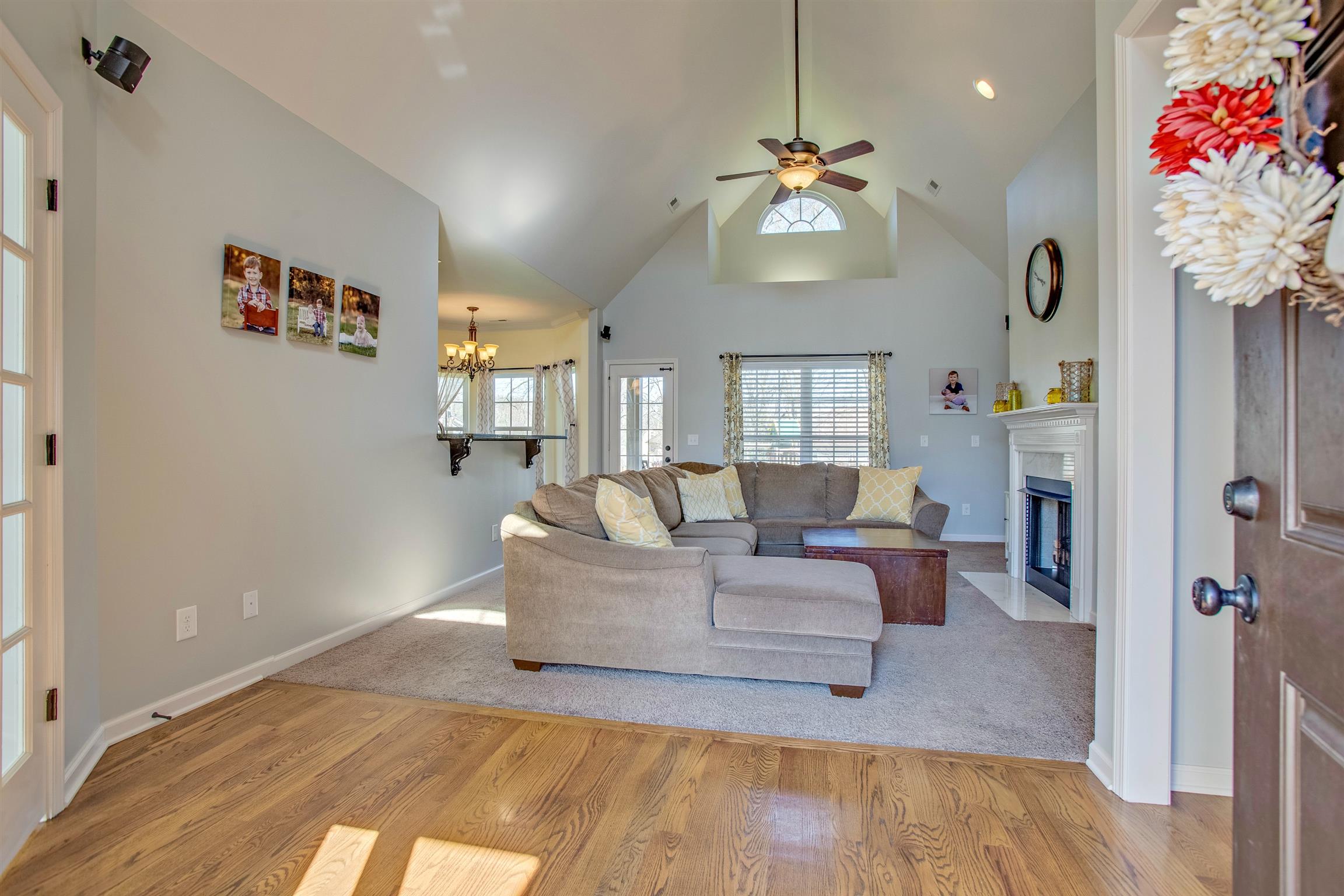 1080 Golf View Way Spring Hill, TN 37174 - Photo 6 of 28 a living room with furniture and a chandelier