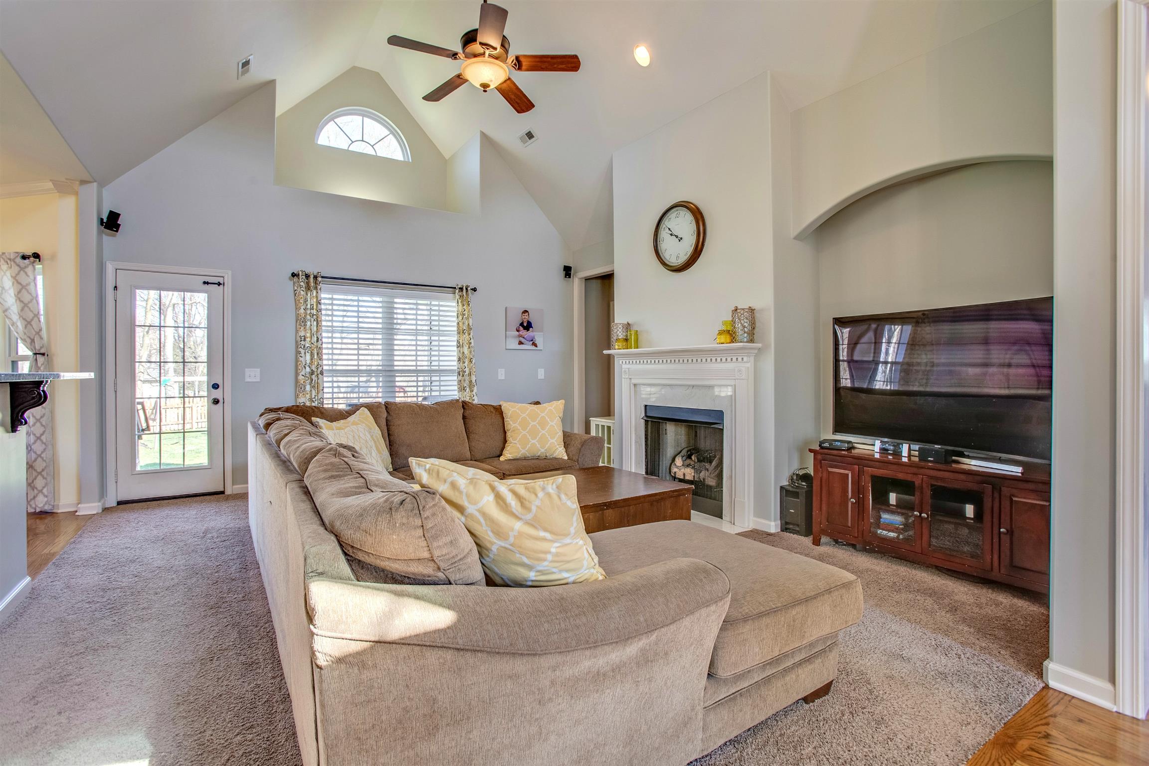 1080 Golf View Way Spring Hill, TN 37174 - Photo 7 of 28 a living room with furniture a fireplace and a flat screen tv