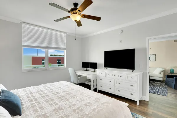 a bedroom with a bed and a flat screen tv