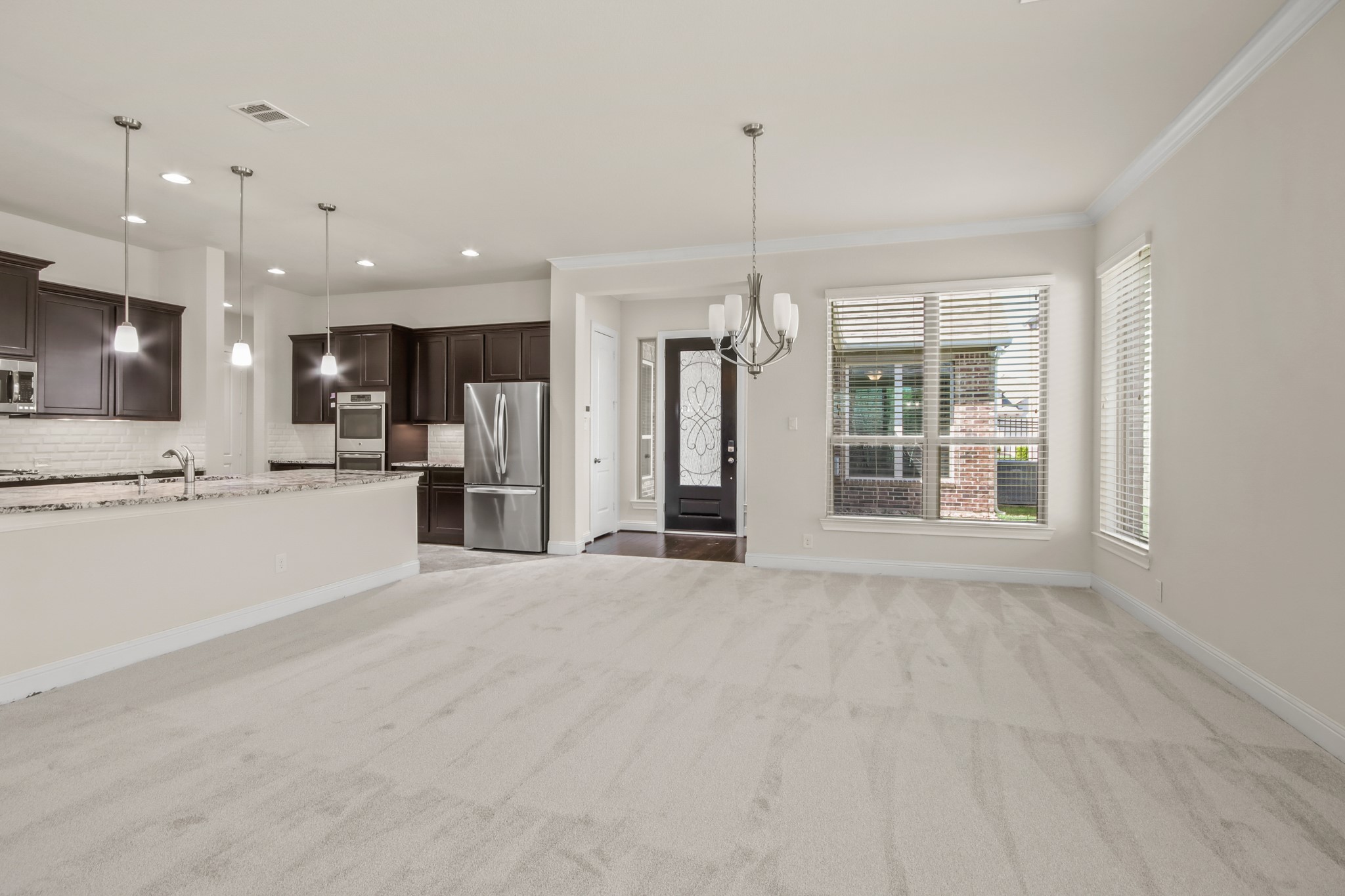 8931 Leaning Hollow Lane Spring, TX 77379 - Photo 5 of 38 Close up view of the Formal Dining Room, front entry door and kitchen.