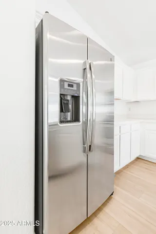 a view of a kitchen with wooden floor and a sink