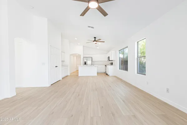 a bedroom with a bed and a white wall