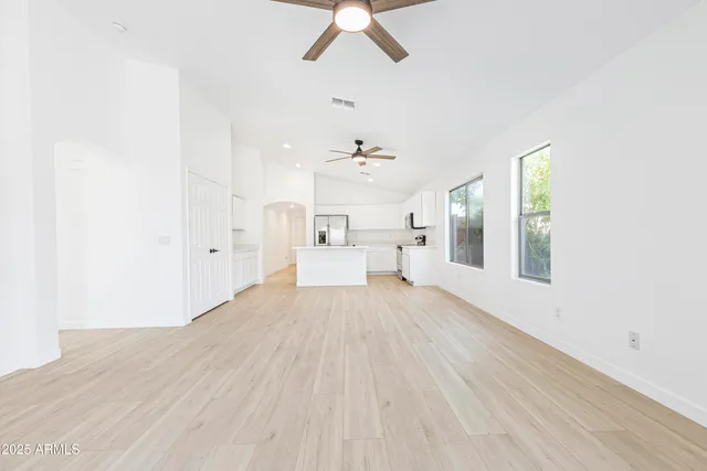 a bedroom with a bed and a white wall
