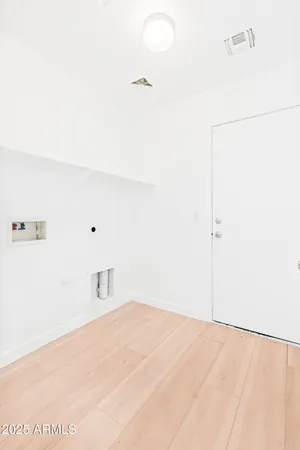 a view of a hallway with wooden floor and closet
